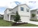 Two-story house with two-car garage and landscaping at 424 Wayland Dr, Haines City, FL 33844