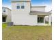 Two-story house with covered patio and grassy yard at 424 Wayland Dr, Haines City, FL 33844