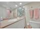 Bathroom features an extended vanity with a large mirror and tub/shower combo at 4831 Saxon Dr # 2270, New Smyrna Beach, FL 32169