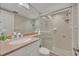 Bathroom features a glass-enclosed shower, light tile, and a vanity with a solid surface counter at 4831 Saxon Dr # 2270, New Smyrna Beach, FL 32169