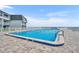 Large, sunny pool area with brick pavers and views of the ocean at 4831 Saxon Dr # 2270, New Smyrna Beach, FL 32169