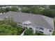 Aerial view of condo building with lush landscaping and a glimpse of a lake at 570 Cranes Way # 248, Altamonte Springs, FL 32701