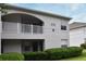 Two-story building exterior with balcony, landscaping, and building number 570 at 570 Cranes Way # 248, Altamonte Springs, FL 32701