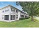 Back exterior shows the screened-in patios of the units and the grassy common area around the building at 570 Cranes Way # 248, Altamonte Springs, FL 32701