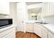 Bright kitchen featuring white cabinetry, modern appliances, and an eat-in area at 570 Cranes Way # 248, Altamonte Springs, FL 32701