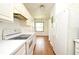 Kitchen with ample lighting featuring white cabinetry and appliances with wood-look vinyl flooring at 570 Cranes Way # 248, Altamonte Springs, FL 32701