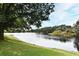 Scenic view of a serene lake surrounded by lush greenery and mature trees, creating a peaceful atmosphere at 570 Cranes Way # 248, Altamonte Springs, FL 32701