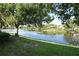 Beautiful lake view with mature trees and lush landscaping reflecting in the calm water at 570 Cranes Way # 248, Altamonte Springs, FL 32701