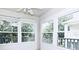 Bright sunroom featuring multiple windows offering lots of natural light and views of the surrounding greenery at 570 Cranes Way # 248, Altamonte Springs, FL 32701