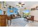 Cozy living room featuring a brown leather sofa and backyard view at 12013 Woodglen Cir, Clermont, FL 34711