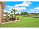 Beautiful backyard with a lush lawn and patio area with palm trees at 2685 Star Grass Cir, Kissimmee, FL 34746