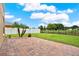 Spacious backyard with a brick patio, green lawn, and fencing at 2685 Star Grass Cir, Kissimmee, FL 34746