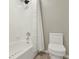 Clean bathroom with a shower-tub combo and a modern toilet at 2685 Star Grass Cir, Kissimmee, FL 34746