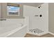 Bright bathroom with a soaking tub and a separate shower stall at 2685 Star Grass Cir, Kissimmee, FL 34746