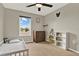 Well-lit bedroom with a window, ceiling fan, and furniture at 2685 Star Grass Cir, Kissimmee, FL 34746