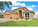 Well-maintained home featuring a manicured front yard, brick walkway, and a welcoming front door at 2685 Star Grass Cir, Kissimmee, FL 34746