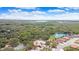 Aerial view of the community showing a pool, tennis courts, and surrounding landscape at 3047 Sangria St, Kissimmee, FL 34744