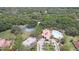 An aerial view showcases tennis courts, a pool, clubhouse, parking and lush greenery at 3047 Sangria St, Kissimmee, FL 34744