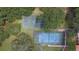 Aerial view of community tennis and basketball courts surrounded by lush trees at 3047 Sangria St, Kissimmee, FL 34744