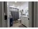 Well-lit bathroom with a shower featuring a gray curtain, and a vanity with a sleek countertop at 3047 Sangria St, Kissimmee, FL 34744