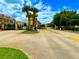 Gated community entrance with mature palm trees, colorful signage and landscaping at 3047 Sangria St, Kissimmee, FL 34744