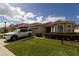 Exterior view of a well-kept home with a tile roof, bay window, and lush landscaping at 3047 Sangria St, Kissimmee, FL 34744