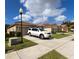 Street view of well-maintained homes, featuring manicured lawns and beautiful landscaping, beneath a bright blue sky at 3047 Sangria St, Kissimmee, FL 34744