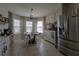 Bright kitchen nook featuring a round table set, decorative shelves, and stainless steel refrigerator at 3047 Sangria St, Kissimmee, FL 34744