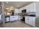 Bright kitchen featuring stainless steel appliances, white cabinetry, modern backsplash, and recessed lighting at 3047 Sangria St, Kissimmee, FL 34744