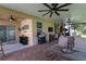 Large covered patio with a grill, seating area, and stylish decor at 3047 Sangria St, Kissimmee, FL 34744