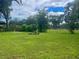 Large grassy backyard with stone picnic table, providing ample outdoor space at 858 Darwin Dr, Altamonte Springs, FL 32701