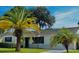 Newly painted white single story house with dark navy blue shutters and front door at 858 Darwin Dr, Altamonte Springs, FL 32701