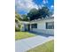 White single story house with a newly paved driveway and grassy lawn at 858 Darwin Dr, Altamonte Springs, FL 32701