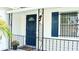 Navy blue front door with a glass window and black metal railing at 858 Darwin Dr, Altamonte Springs, FL 32701