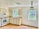 Bright kitchen with light-colored cabinets, wood floors, and a chandelier at 858 Darwin Dr, Altamonte Springs, FL 32701