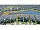 Aerial view of a modern home with a lake view and community amenities including a golf course at 8938 Cabot Cliffs Dr, Davenport, FL 33896
