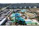 Aerial view showcasing a community's water park, playground, pool and green spaces at 8938 Cabot Cliffs Dr, Davenport, FL 33896