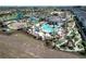 Aerial view of community pool, water park, sand court, and putting green at 8938 Cabot Cliffs Dr, Davenport, FL 33896