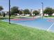 Community basketball court with vibrant blue and red court lines, providing a recreational space for sports enthusiasts at 8938 Cabot Cliffs Dr, Davenport, FL 33896