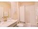 Well-lit bathroom with white-tiled shower and tub and modern sink at 8938 Cabot Cliffs Dr, Davenport, FL 33896