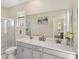 Elegant bathroom with double vanity, framed mirrors, and a walk-in glass enclosed shower at 8938 Cabot Cliffs Dr, Davenport, FL 33896