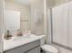 Bright bathroom featuring a modern vanity, decorative wall art, and shower with patterned curtain at 8938 Cabot Cliffs Dr, Davenport, FL 33896