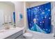 The Frozen themed bathroom features bright lighting, a white vanity, and a Frozen themed shower curtain at 8938 Cabot Cliffs Dr, Davenport, FL 33896