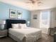 Bright bedroom featuring a large bed with a tufted headboard, soft white linens, and neutral decor at 8938 Cabot Cliffs Dr, Davenport, FL 33896