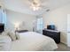 Well-lit bedroom featuring neutral decor, a king bed, and ceiling fan at 8938 Cabot Cliffs Dr, Davenport, FL 33896