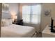 Serene bedroom featuring a queen bed, natural light from the window, and a functional workspace at 8938 Cabot Cliffs Dr, Davenport, FL 33896