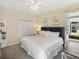 Bright bedroom features a spacious closet, soft lighting, and a comfortable bed with white linens at 8938 Cabot Cliffs Dr, Davenport, FL 33896