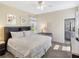 Inviting bedroom with soft lighting, a plush bed, and a view into the en-suite bathroom at 8938 Cabot Cliffs Dr, Davenport, FL 33896