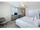 Neat bedroom featuring neutral decor, dresser with television, and closet for organized storage at 8938 Cabot Cliffs Dr, Davenport, FL 33896