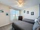 Shared bedroom offering twin beds, neutral decor, and natural light from the window at 8938 Cabot Cliffs Dr, Davenport, FL 33896